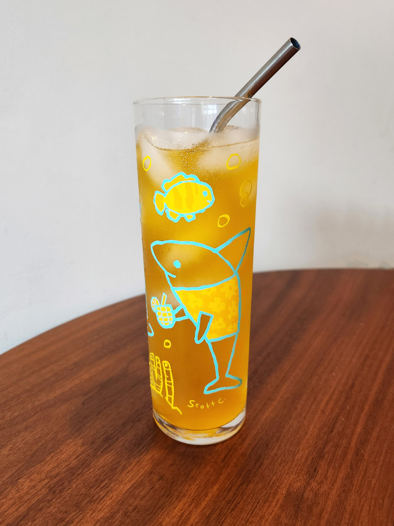 Ocean Life 13.5oz glass photo with orange liquid and a straw